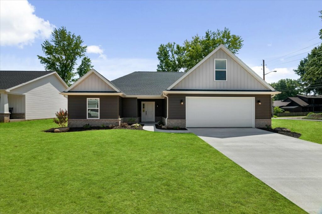 Reinbrecht home with green grass and nice landscaping and overall outdoor appeal