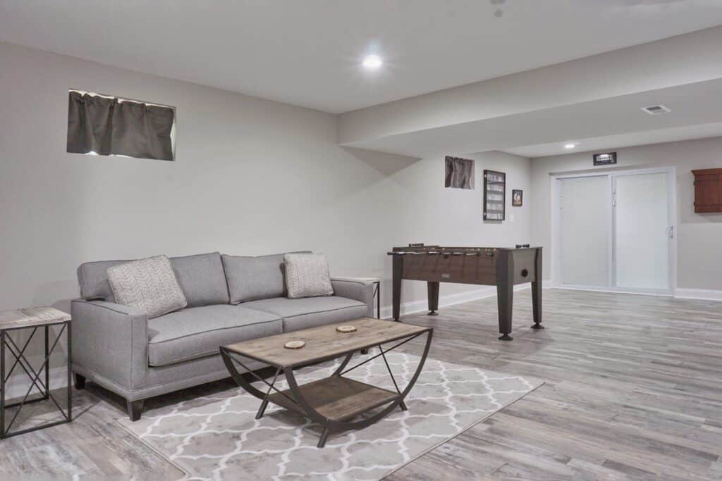 basement adds value to your home concept - A large basement with a modern interior design in bright lighting