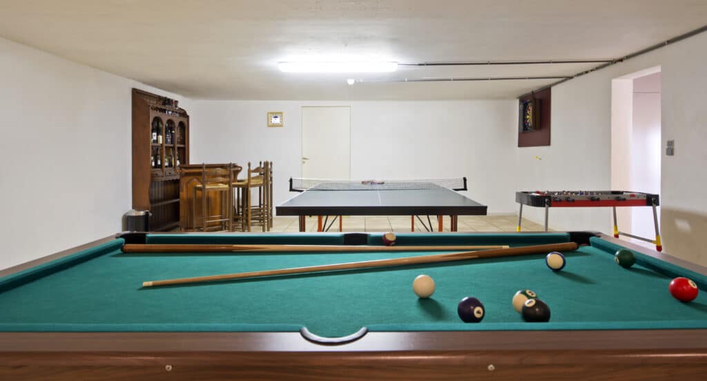 Pool table and ping pong table in basement