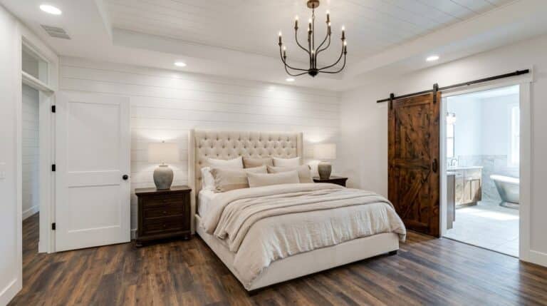 Stylish master bedroom suite featuring a cozy bed and elegant decor.