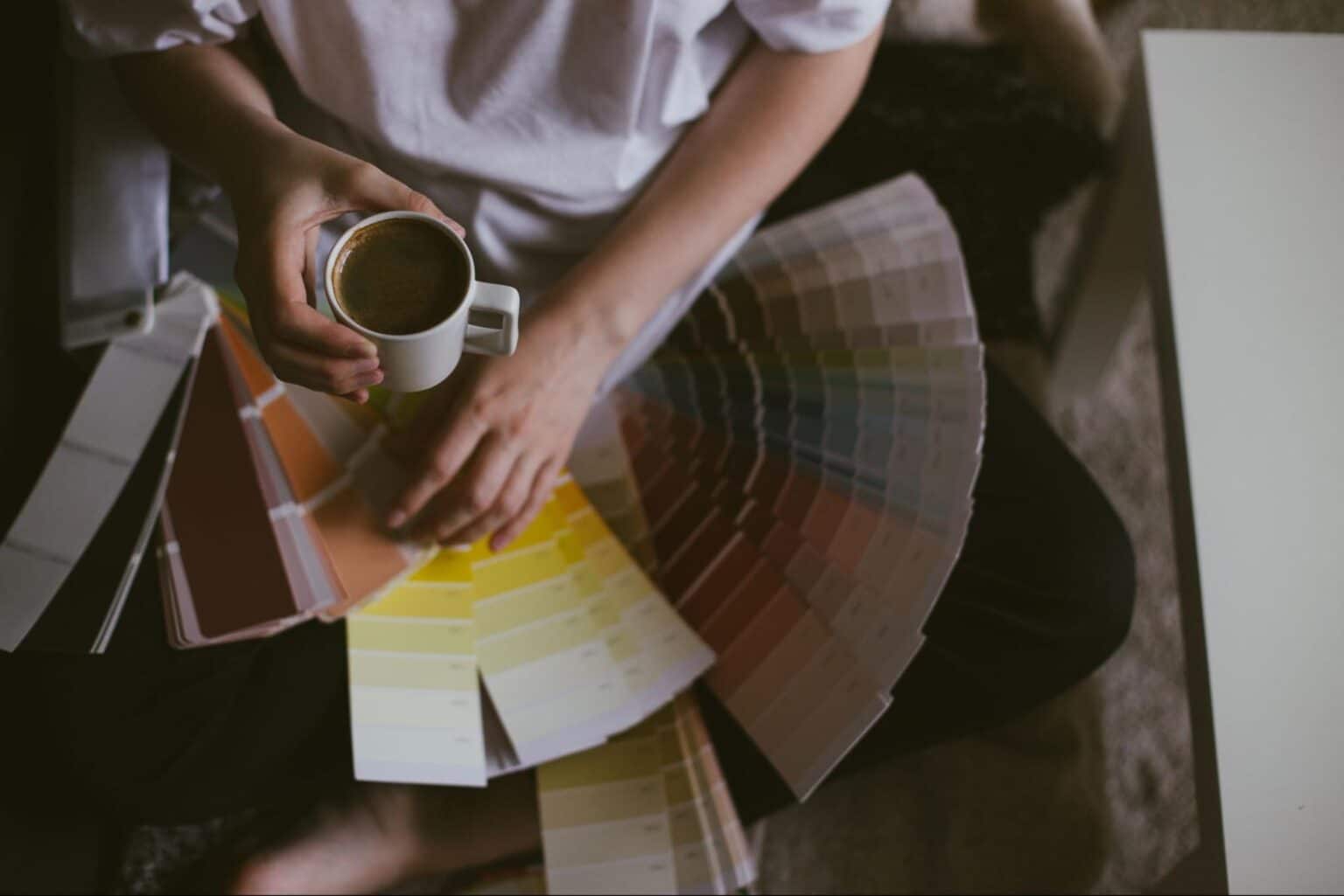 Enjoying coffee while exploring creative color palettes for design inspiration.