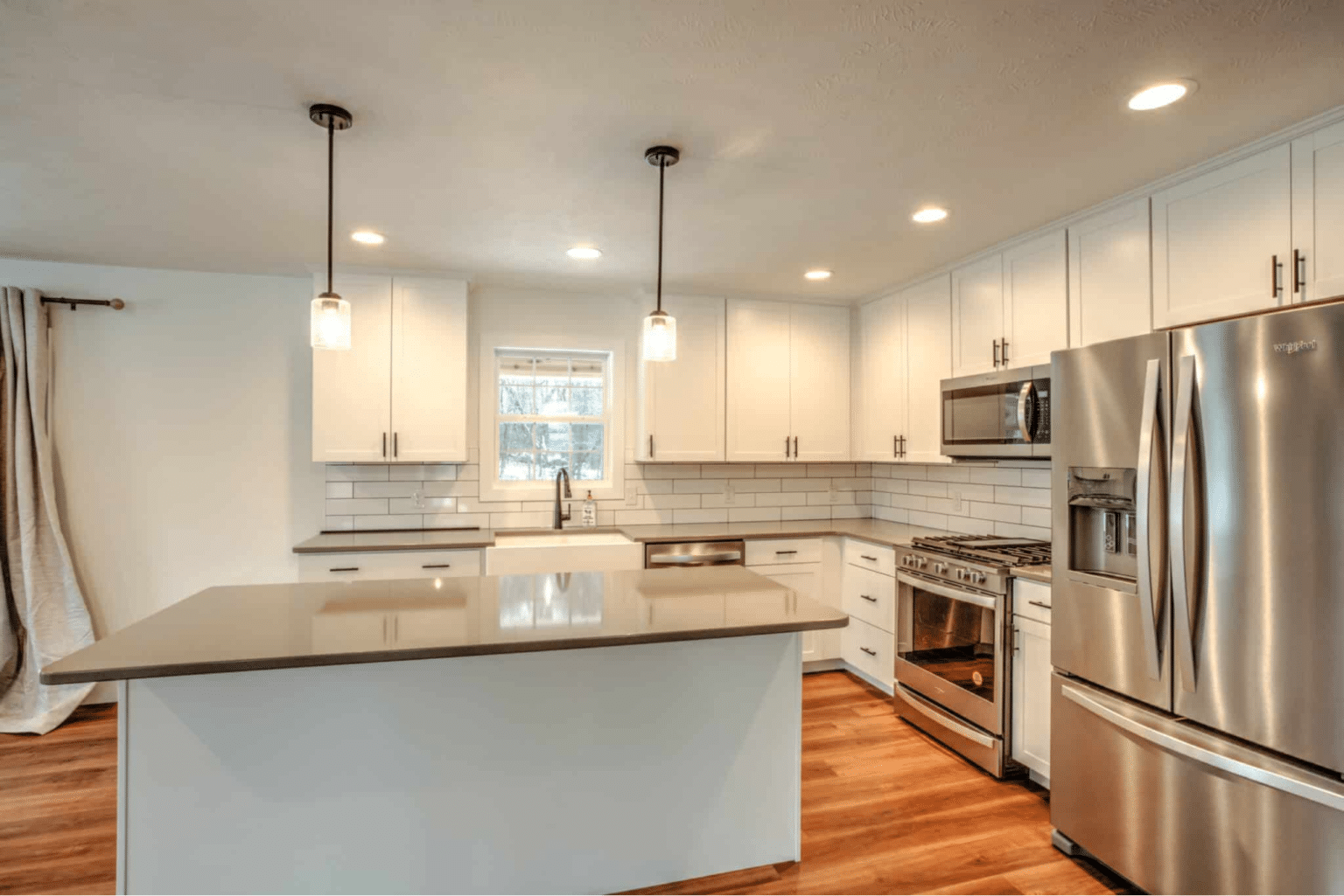 Sleek modern kitchen design with stainless steel appliances and bright open layout.