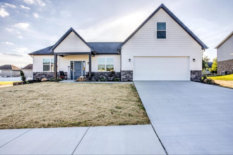 Charming modern home with attractive landscaping and inviting front porch.