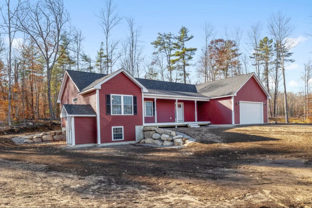 Charming red house nestled in serene natural surroundings.