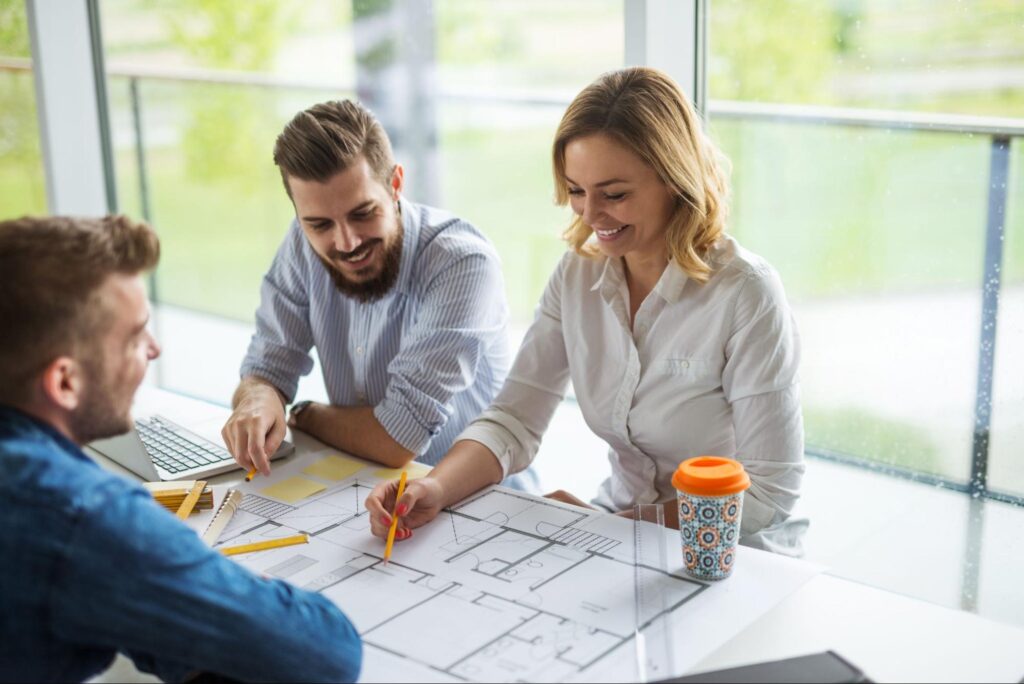 Team members brainstorming and collaborating during a planning session at the office.