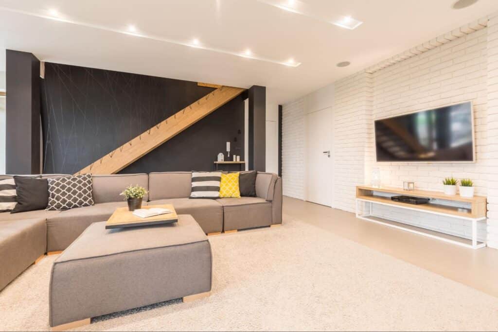 Stylish modern living room with comfortable seating in a finished basement.