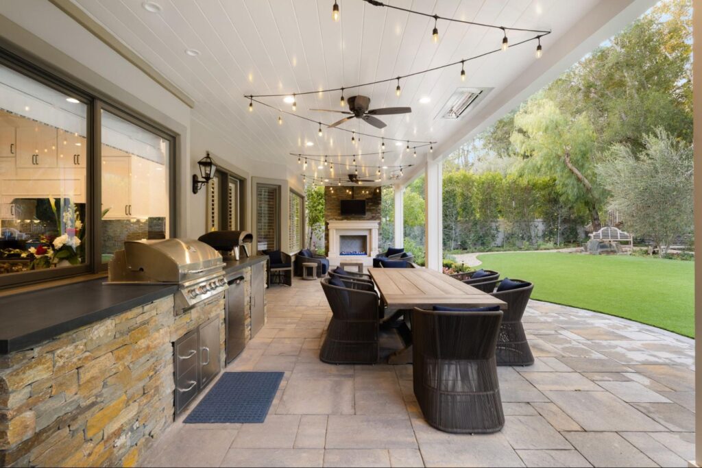 Cozy outdoor dining area with string lights and modern furnishings ata aa new home