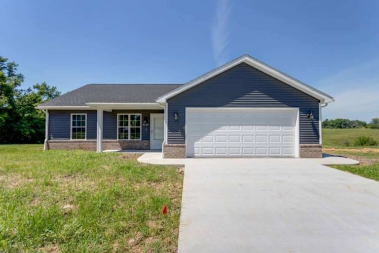 New single-family home showcasing modern architecture and spacious front lawn.
