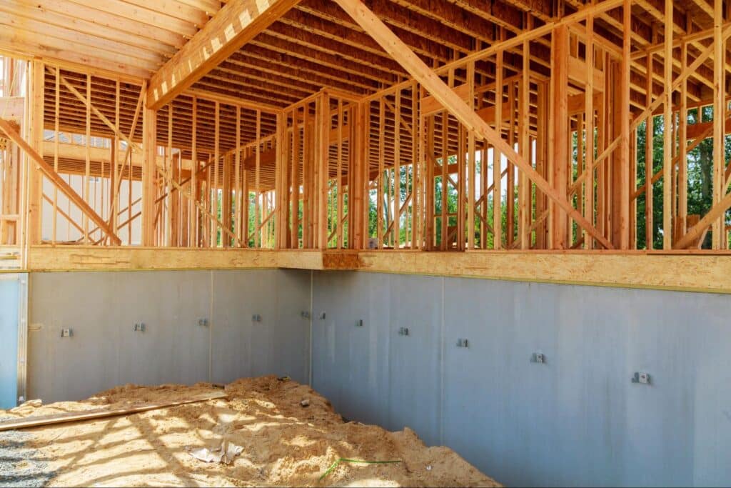 Wooden framing and basement foundation under construction for our new home.