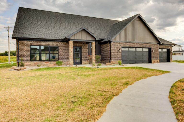 Stylish brick home with a beautiful driveway and charming design features.