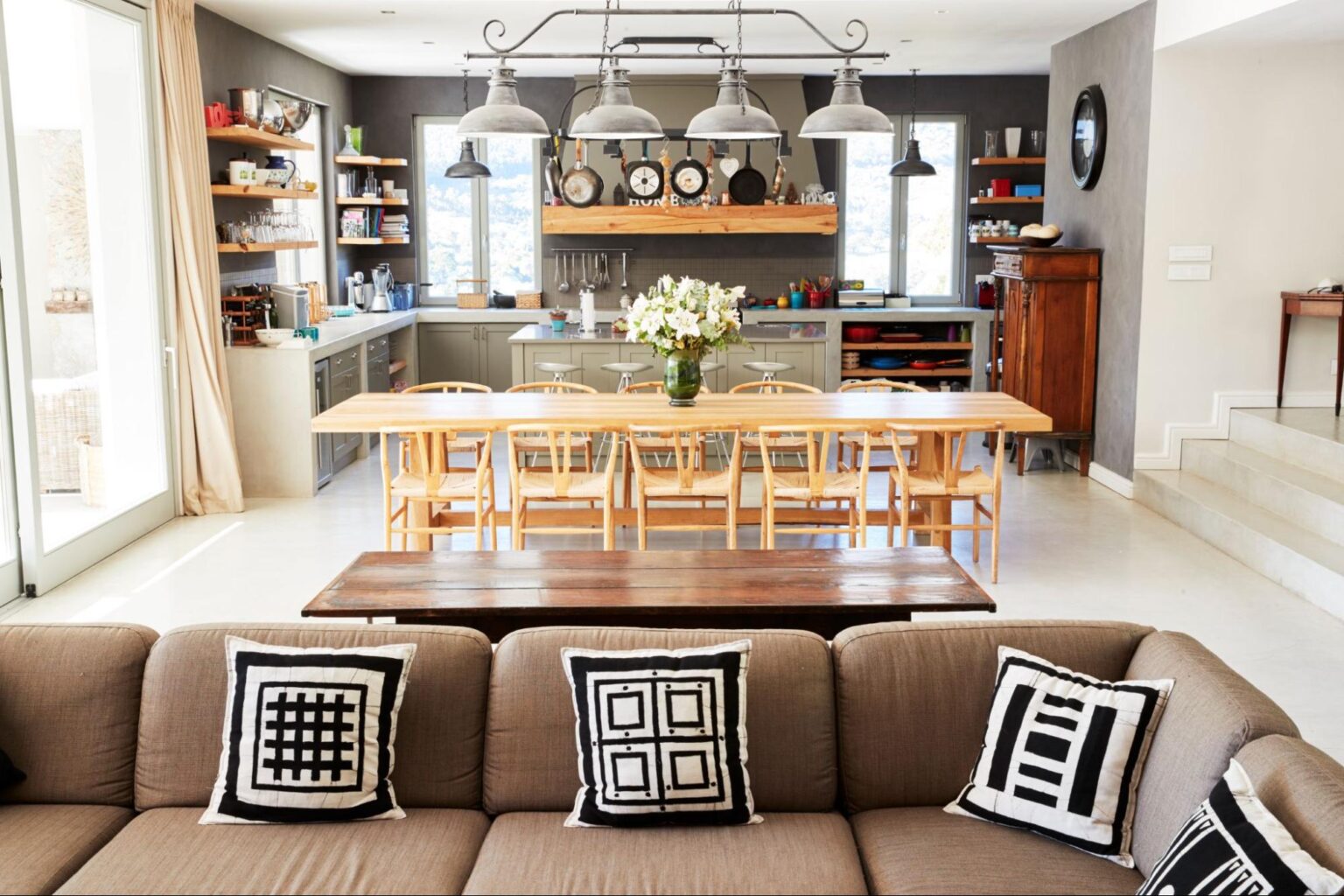 Stylish kitchen and living room design with modern furniture and decor accents.