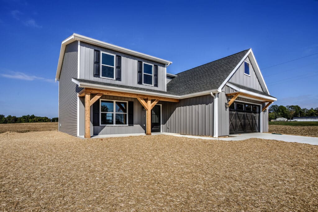 Stylish new home exterior featuring modern design and a spacious yard.
