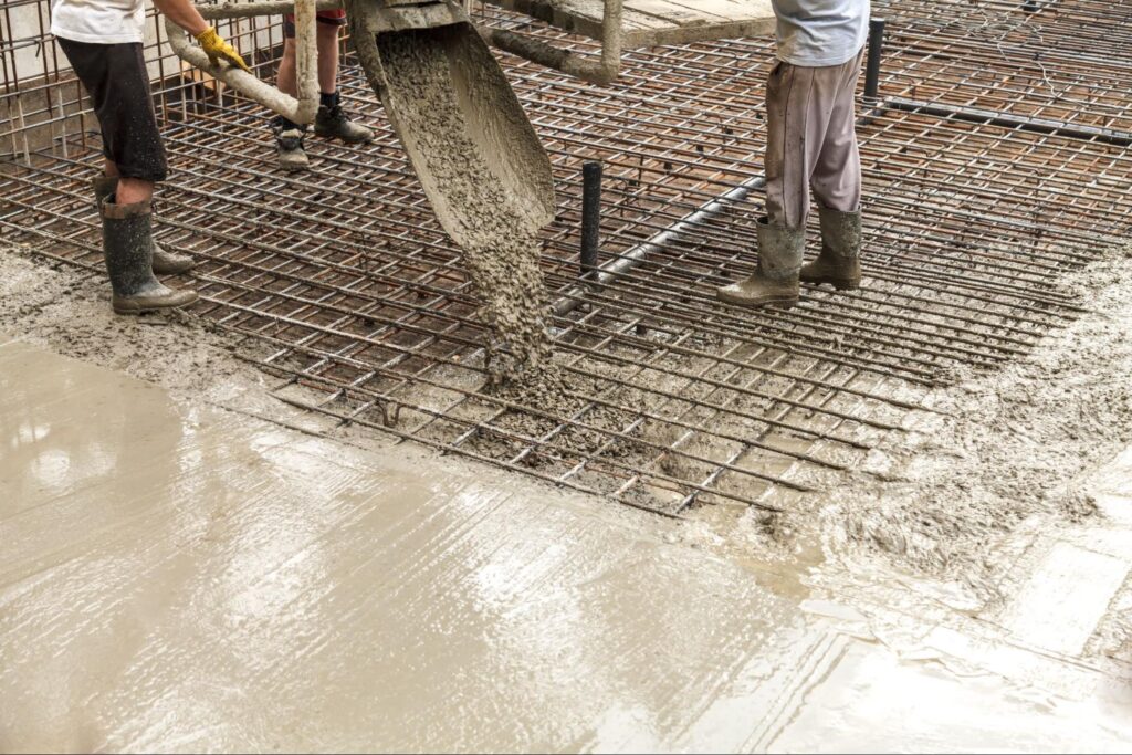 Pouring fresh concrete to create a durable construction foundation.