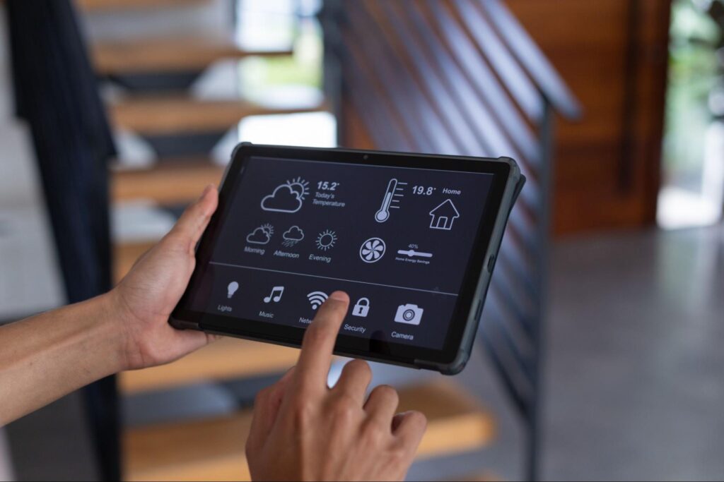 Smart home tablet managing climate, music, and energy for enhanced comfort settings.