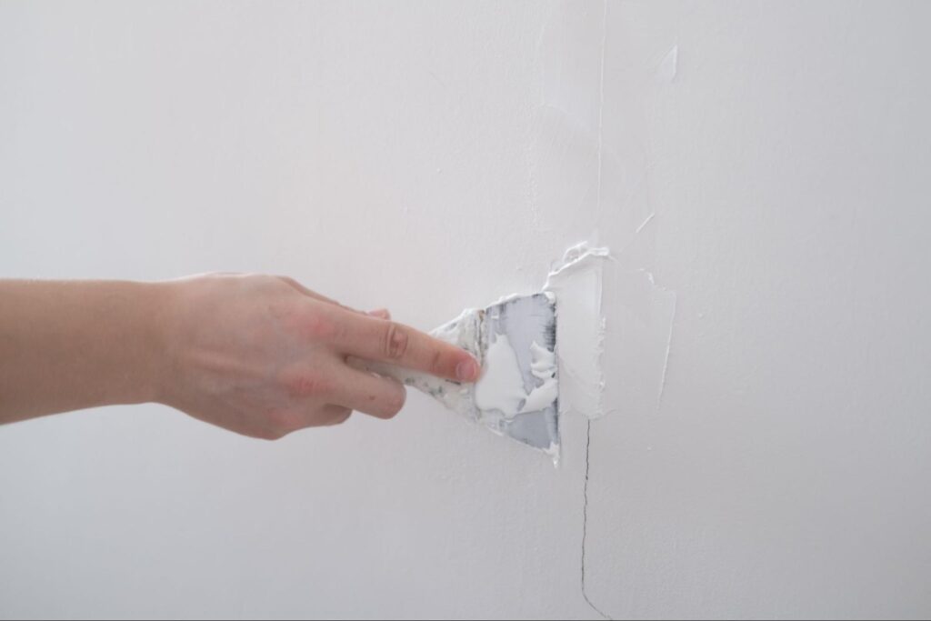 Applying fresh paint to a wall for a home improvement project.