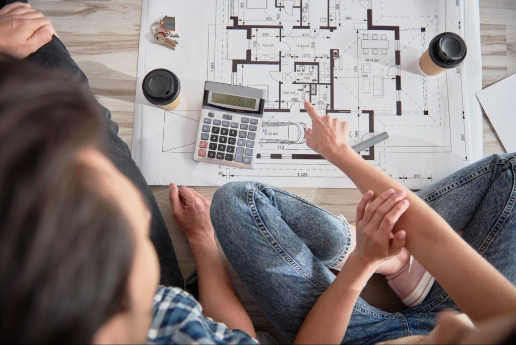 Collaborative home design planning over coffee and blueprints for ideal spaces.