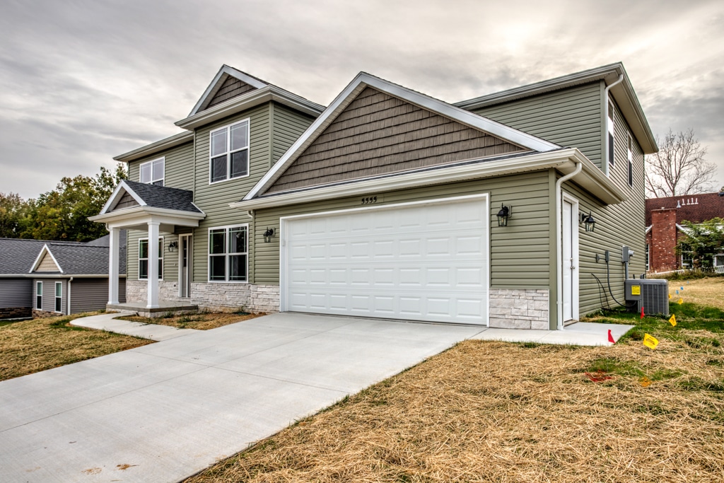 Inviting family home with attractive landscaping and a spacious garage.