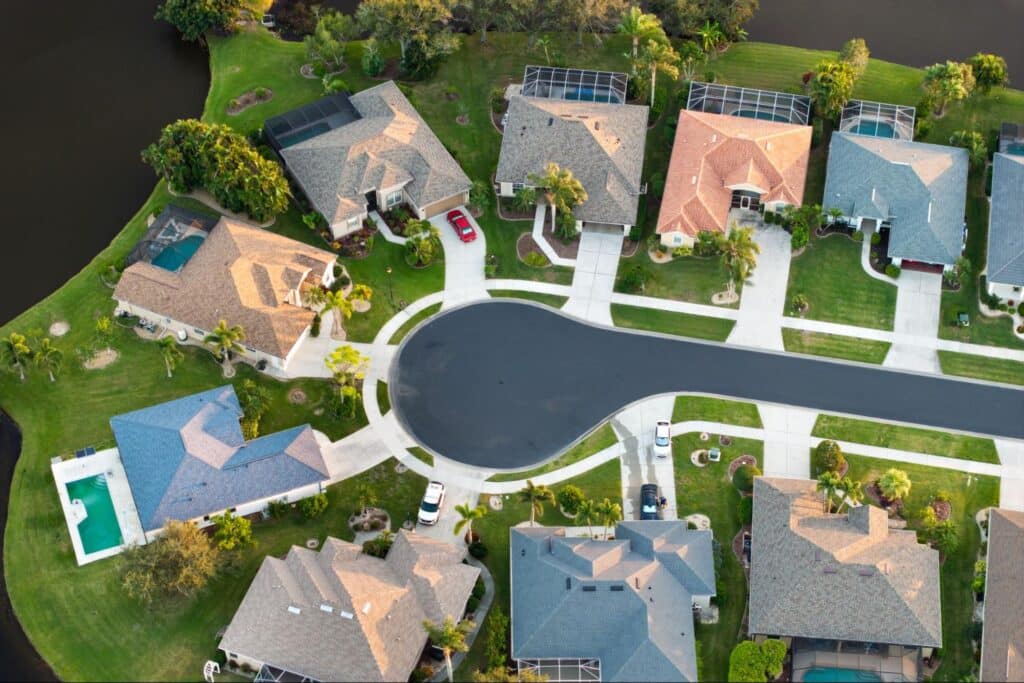 Aerial view of a serene neighborhood with landscaped homes and circular street design.
