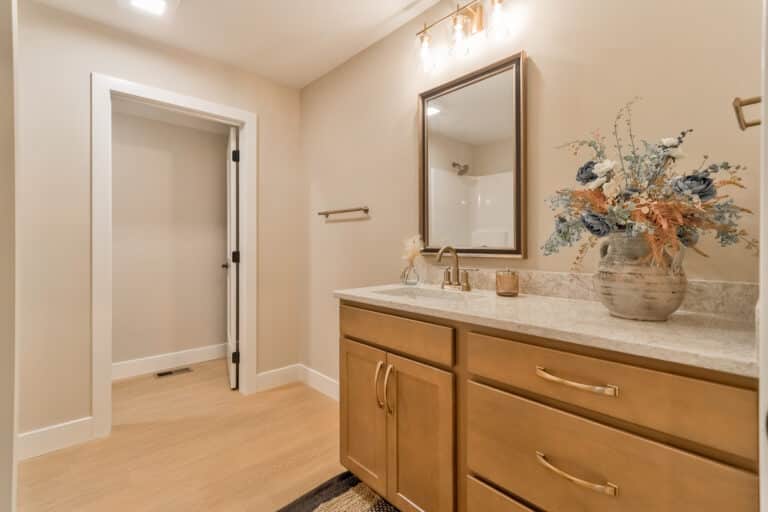 Elegant bathroom interior with stylish vanities, modern decor, and floral accents.
