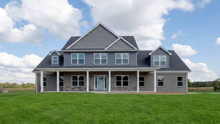 Modern home with a vibrant lawn beneath a clear blue sky.