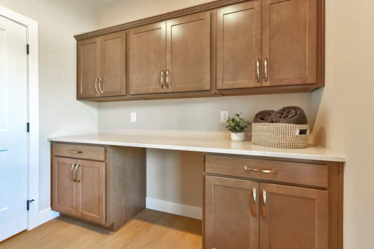 Modern laundry space with cabinets, storage, and organization for efficient cleaning.