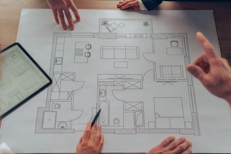 Team collaborating on a modern home design layout and floor plan.