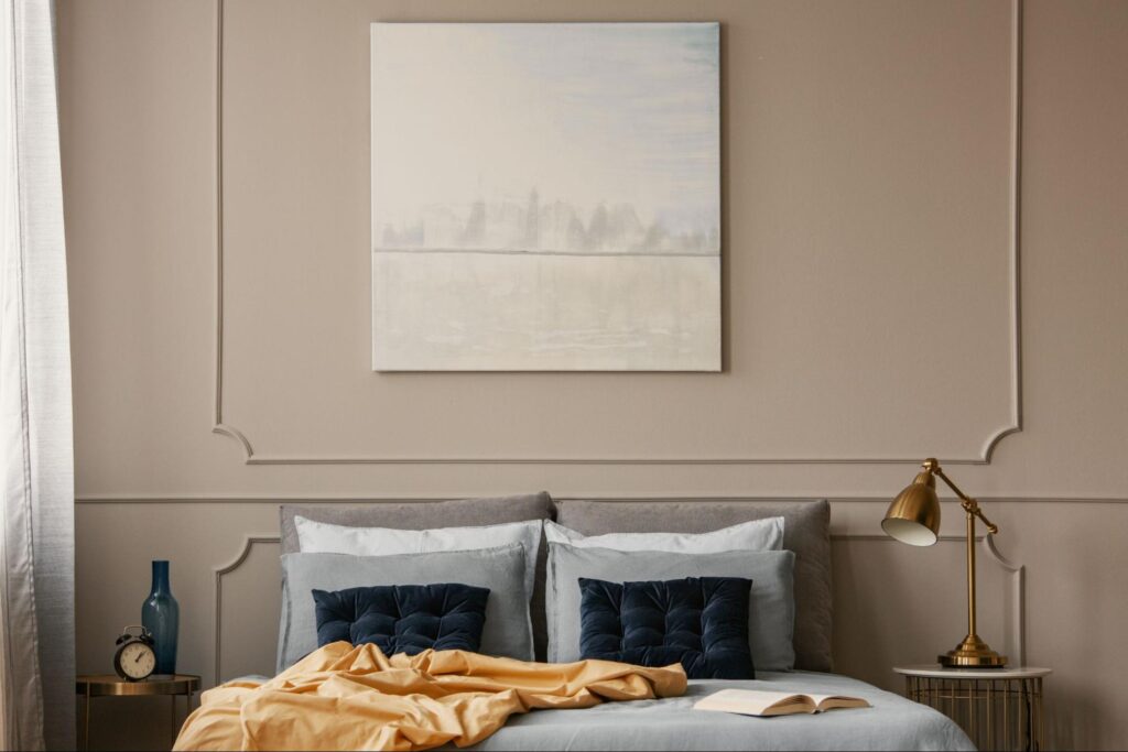 Stylish cozy bedroom with elegant decor and serene wall art.