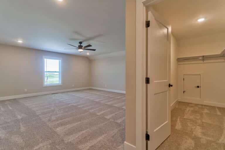 Spacious and cozy bedroom with natural light and modern closet features.