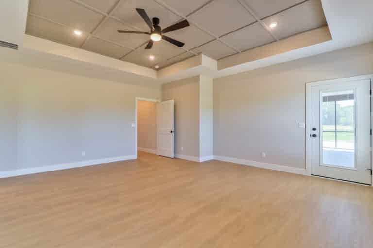 Spacious empty living room with natural light and modern features for design inspiration.