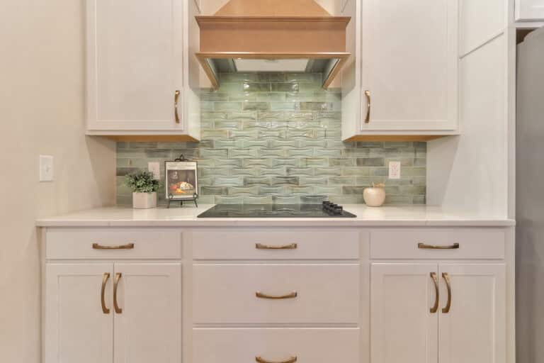 Modern kitchen cabinets with elegant design and stylish backsplash in a contemporary setting.