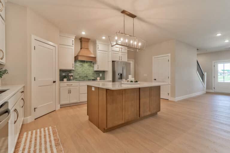 Modern kitchen interior featuring elegant design and a spacious island with natural light.