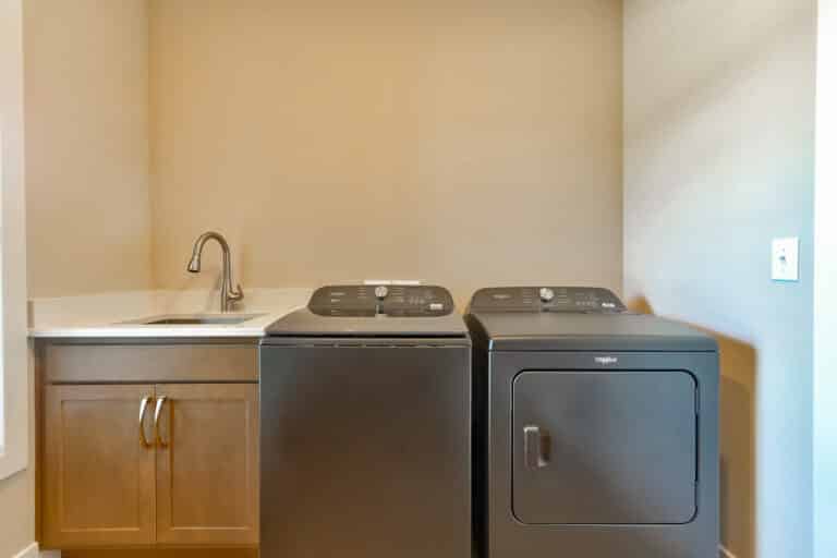 Modern laundry room setup with washer, dryer, and utility sink for efficient home chores.