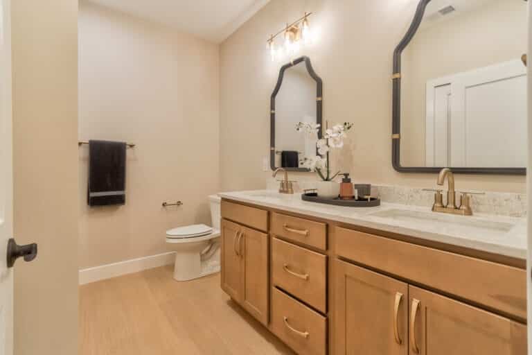Elegant modern bathroom design featuring a stylish vanity, decorative mirror, and luxurious finishes.