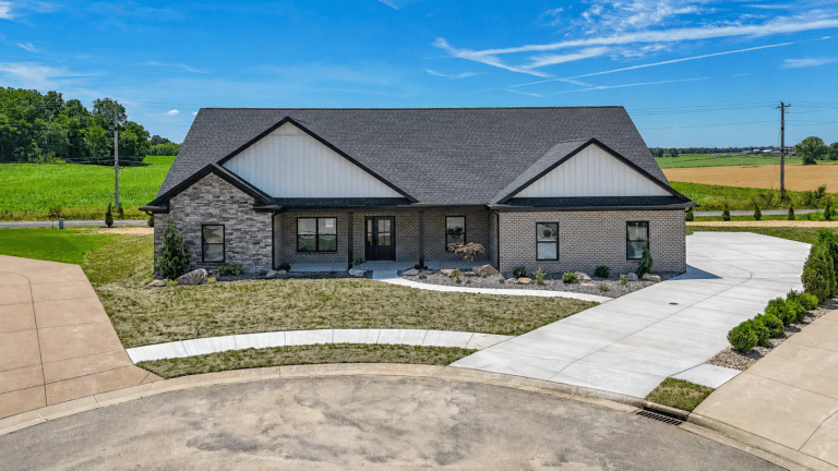 Contemporary brick home design with modern landscaping in a scenic rural setting.