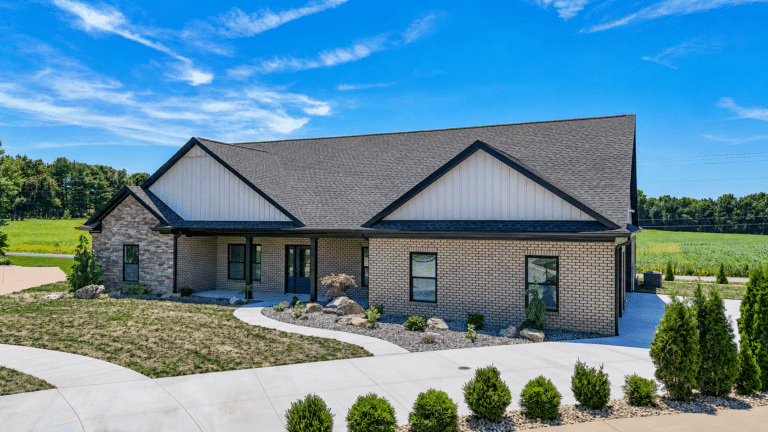 Stylish modern home exterior with landscaped yard and vibrant greenery.