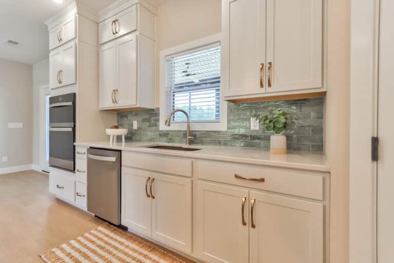 Stylish modern kitchen with sleek cabinets and elegant gray backsplash design.