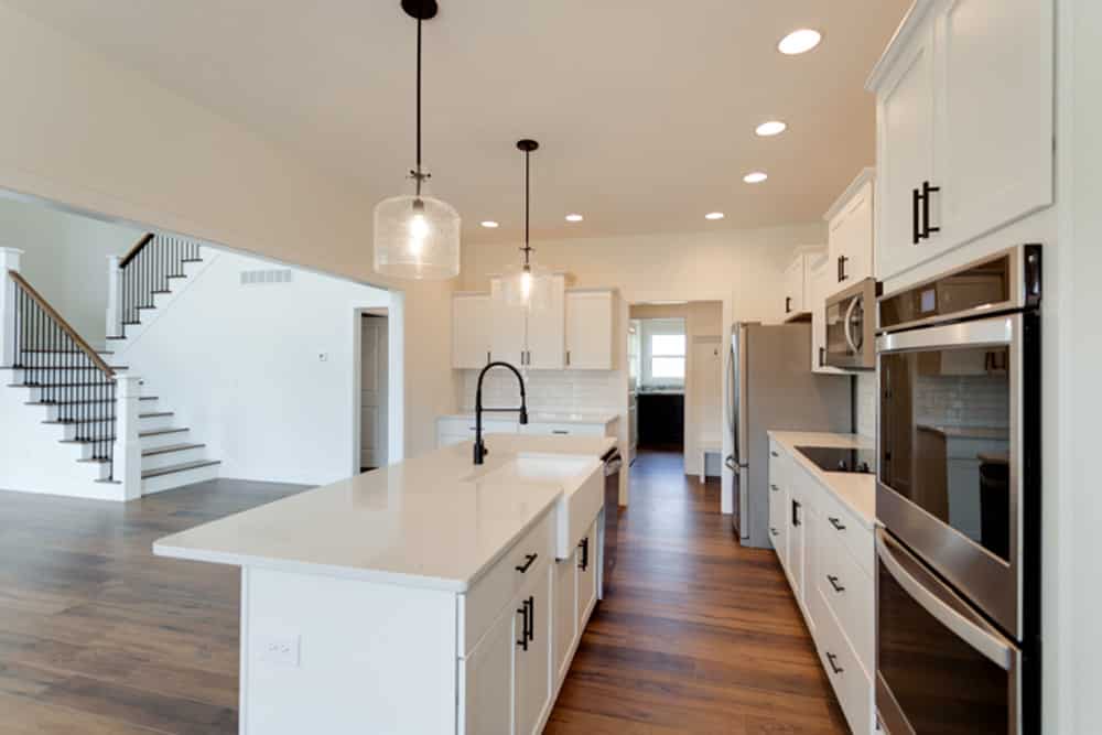 Stylish open-concept kitchen featuring modern appliances and elegant lighting.