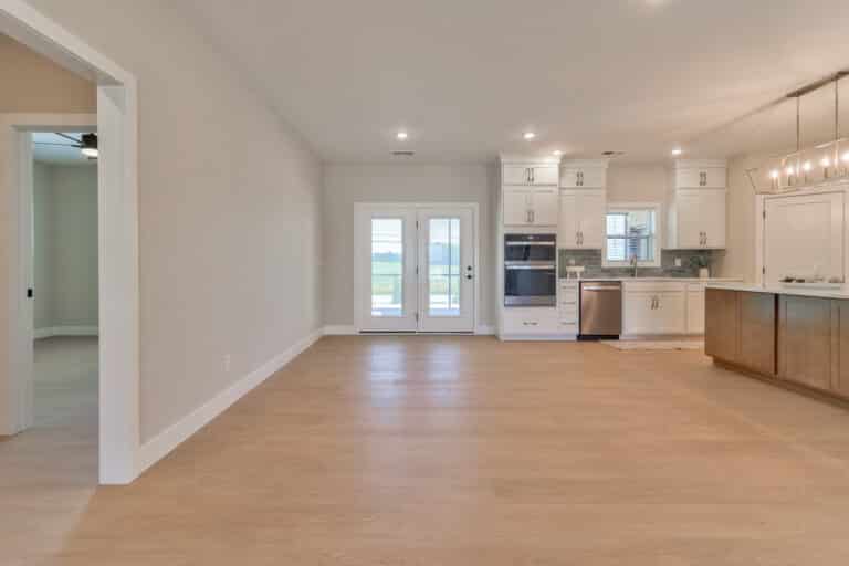 Bright open-concept modern kitchen featuring sleek cabinets and stainless steel appliances.