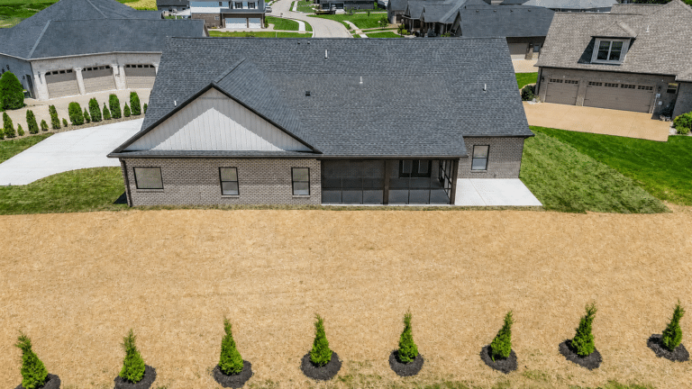 Contemporary home exterior with landscaped yard and fresh front view.