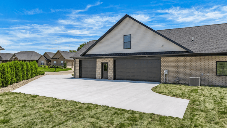Modern house exterior with garage and landscaped yard in a scenic neighborhood.