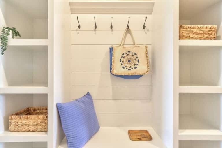 Stylish shelving with a bag and decorative elements for organized home storage.