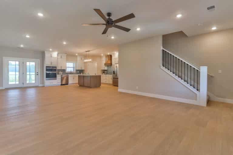Modern spacious living room with hardwood floors and open concept design.