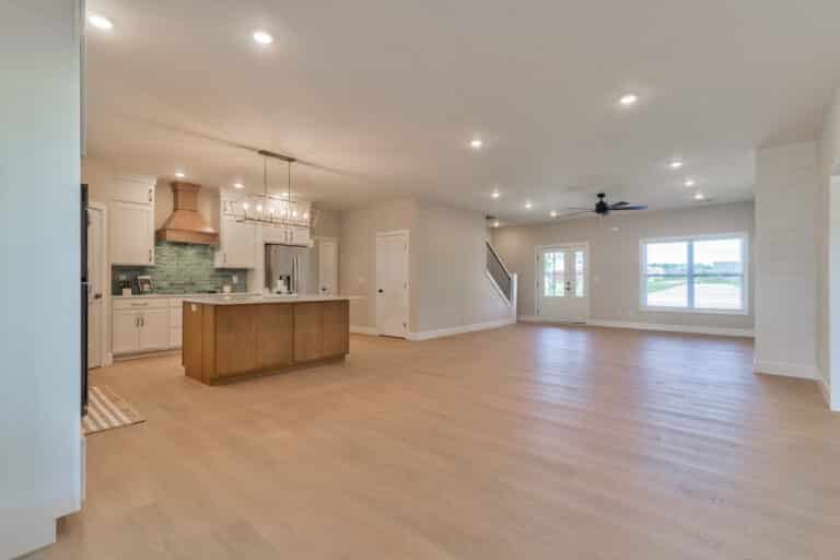 Modern spacious living room and kitchen with natural light and elegant finishes.