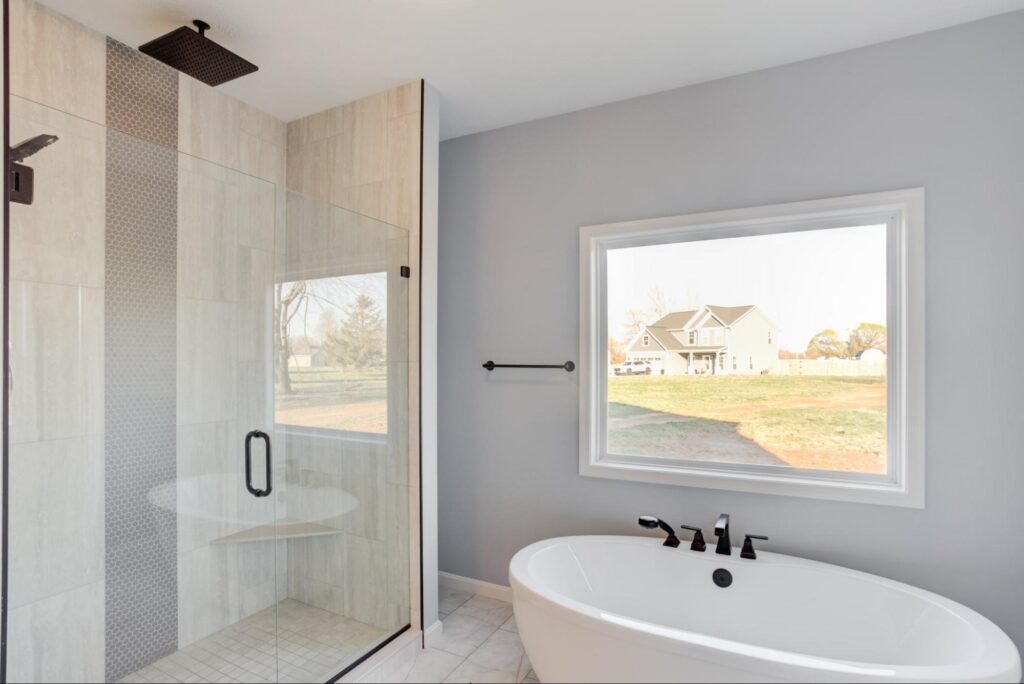 Chic modern bathroom featuring a shower, freestanding tub, and ample natural light.
