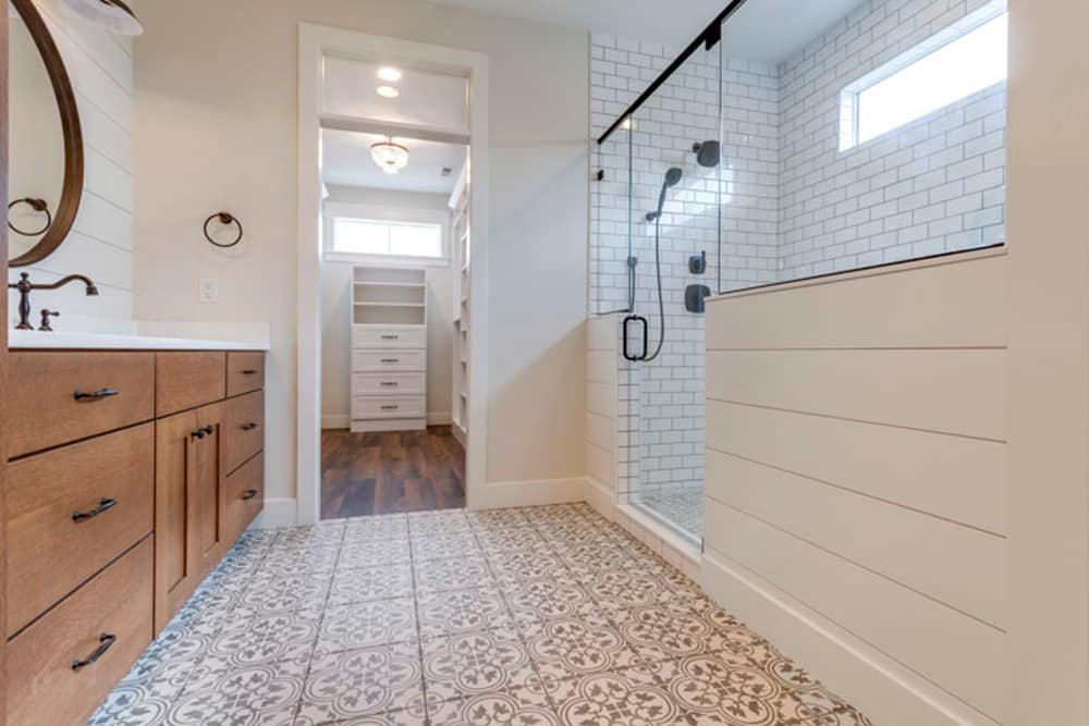 Stylish modern bathroom featuring elegant design, glass shower, and wooden vanity.