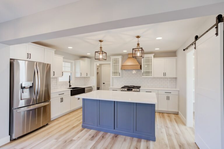 Sleek modern kitchen featuring a stylish island and elegant lighting fixtures.