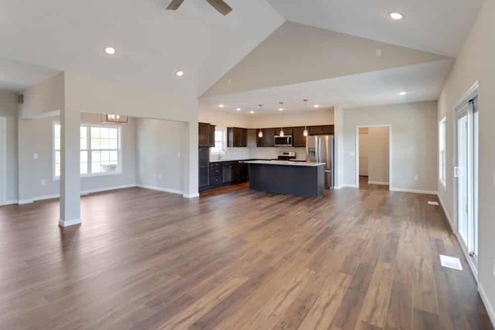 Inviting modern kitchen and living area with hardwood floors, ideal for gatherings.