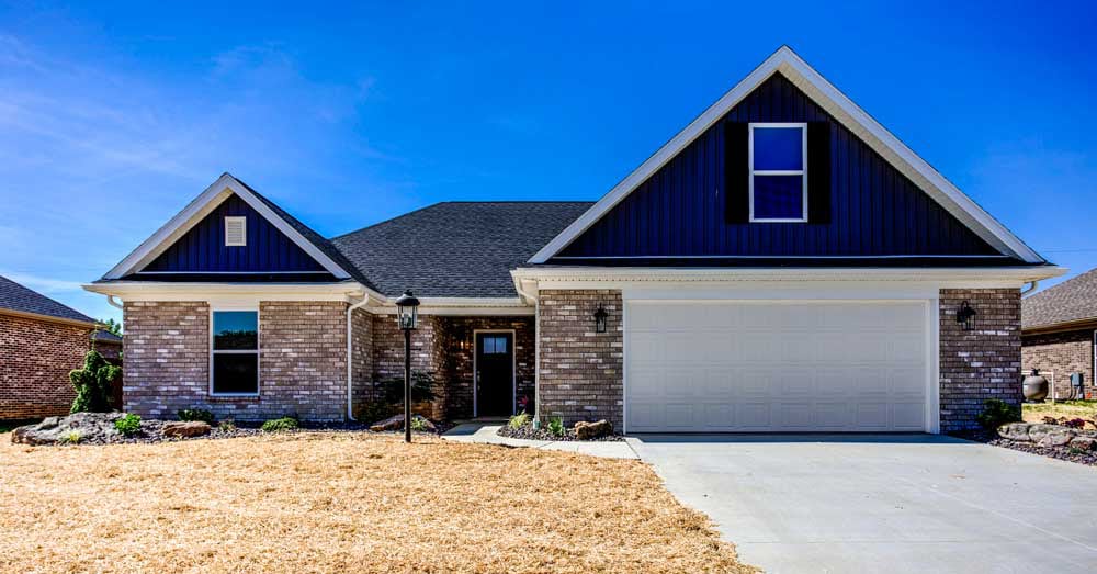 Modern home with stone details and blue accents, ideal for families and buyers.