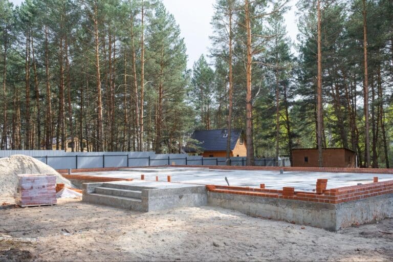 Foundation laid in a tranquil forest, surrounded by trees and natural serenity.
