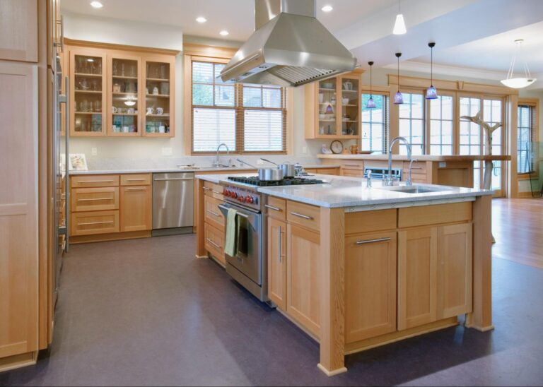 Spacious open kitchen with modern wooden cabinets and a large island countertop.
